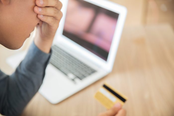 businessman looking credit card stress