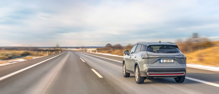 modern crossover car driving winter highway open countryside road travel transport