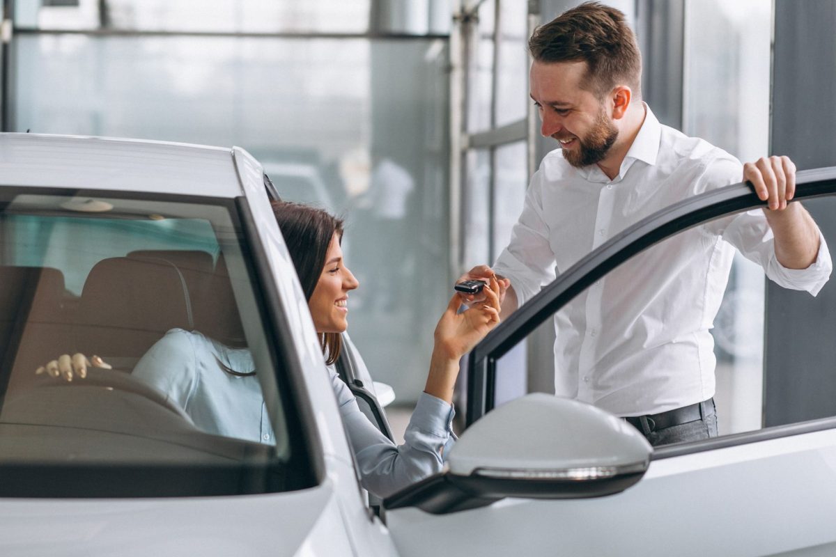 salesman woman looking car car showroom 4 1