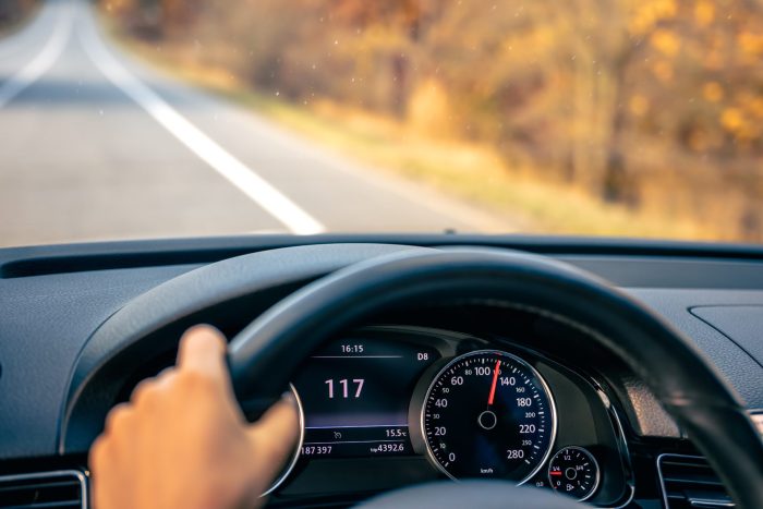 steering wheel car close up high speed driving road