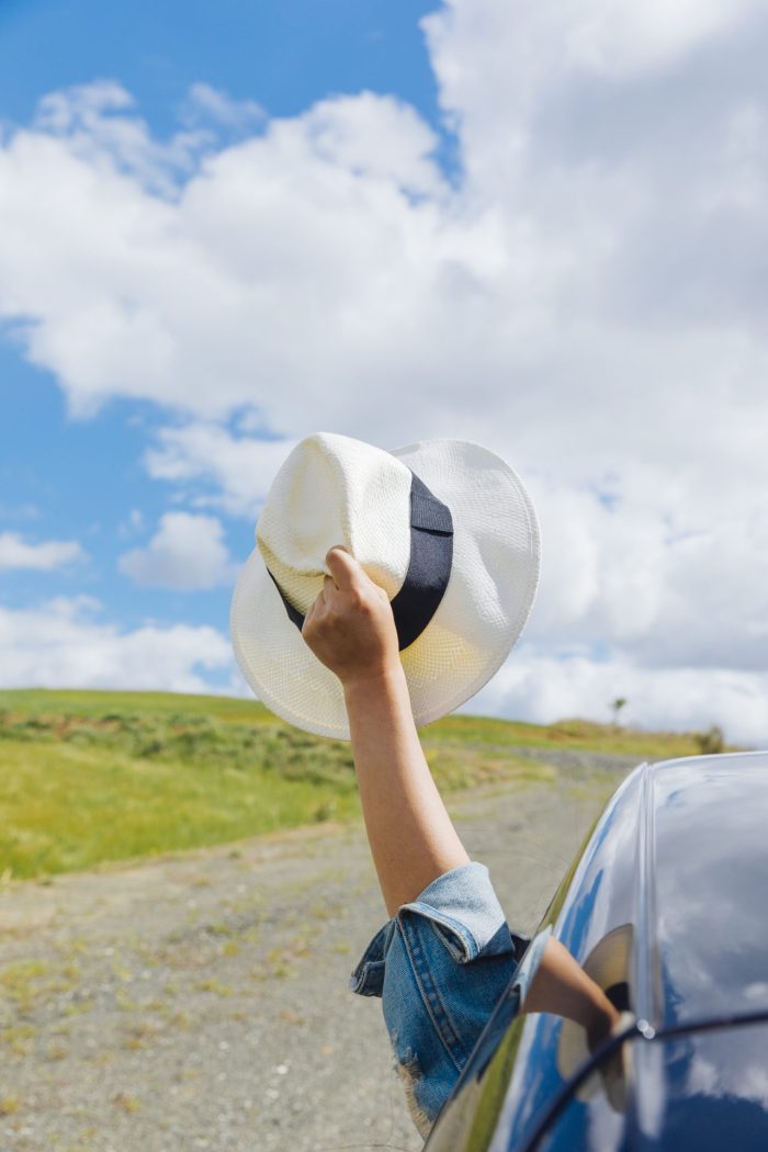 woman hand with hat against sky